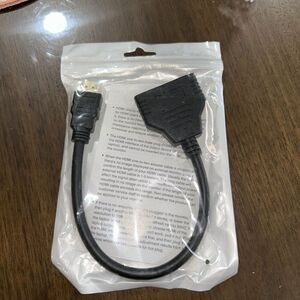 HDMI one-to-two male plug, which is an HDMI splitter.